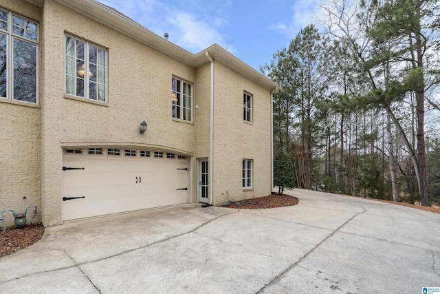 4035 Saint Charles Dr, Hoover, AL 35242 - view of property exterior featuring an attached garage, driveway, and stucco siding