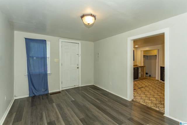 unfurnished room with dark wood-style floors and baseboards