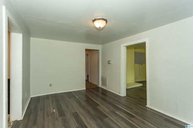 unfurnished room with dark wood-style floors and baseboards