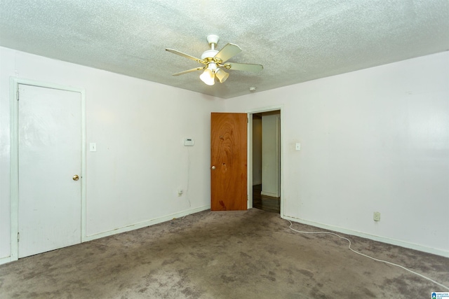 empty room featuring a ceiling fan, carpet floors, baseboards, and a textured ceiling