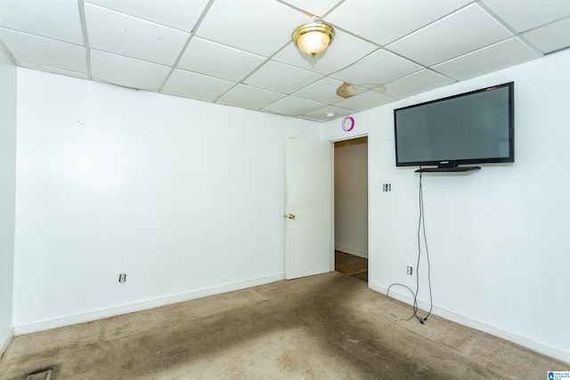 unfurnished bedroom with a drop ceiling, carpet, and baseboards