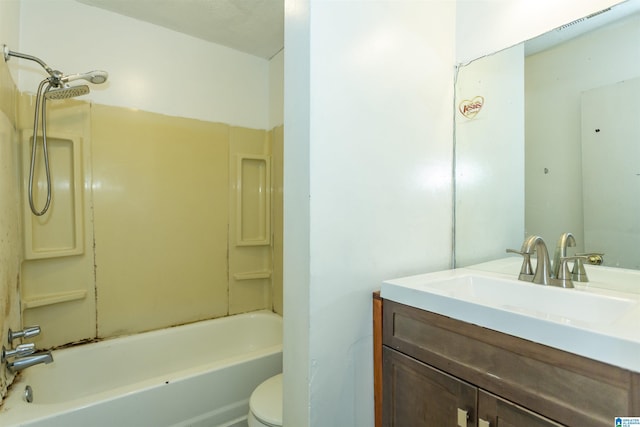 bathroom featuring vanity, bathtub / shower combination, and toilet
