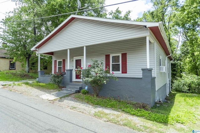 bungalow-style house featuring covered porch and cooling unit