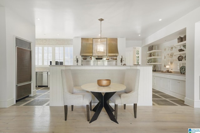 dining room featuring breakfast area, light wood-style floors, and recessed lighting