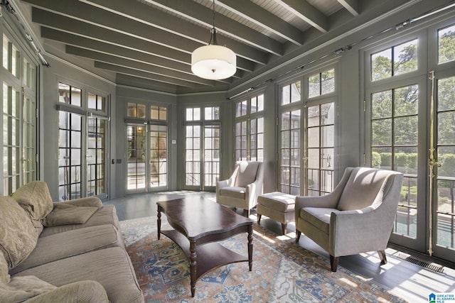 sunroom / solarium featuring french doors, beamed ceiling, and wood finished floors
