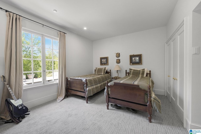 carpeted bedroom featuring baseboards and recessed lighting