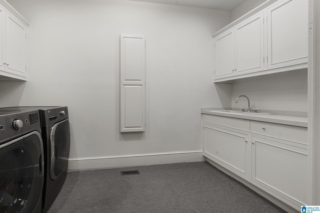 washroom featuring cabinet space, washing machine and dryer, carpet, and baseboards