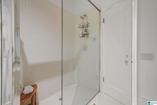 full bathroom with a tile shower and tile patterned floors