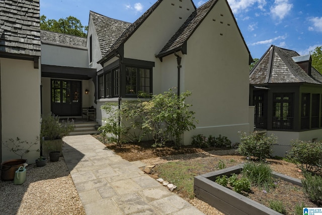 view of side of home with stucco siding