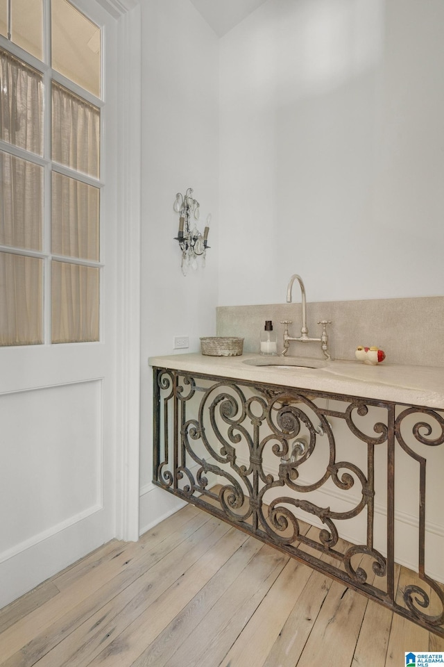 bathroom with a sink and wood finished floors