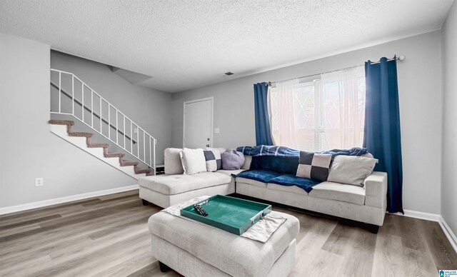 3657 Haven View Cir Unit 3657, Hoover, AL 35216 - living room featuring a textured ceiling, wood finished floors, stairs, and baseboards
