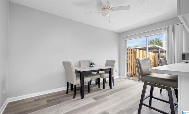 3657 Haven View Cir Unit 3657, Hoover, AL 35216 - dining space with light wood-style floors, ceiling fan, baseboards, and a textured ceiling