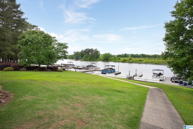 dock area with a water view and a lawn