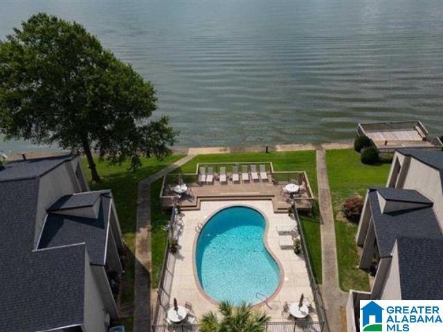 community pool featuring a patio and a water view