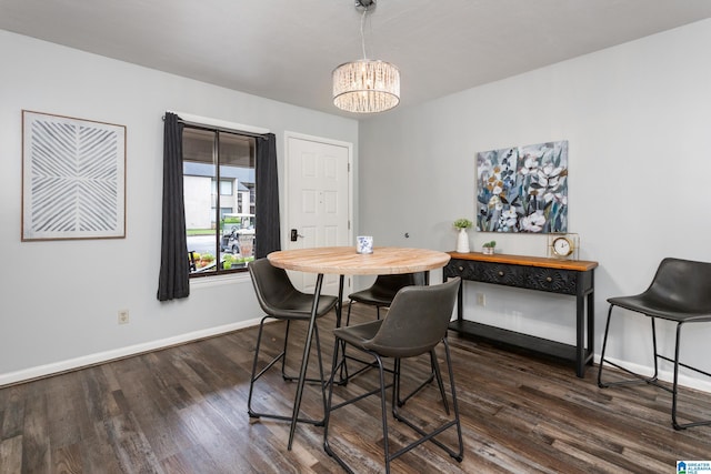 dining space featuring a chandelier, baseboards, and dark wood-type flooring