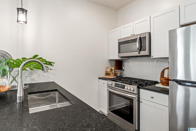 2213 3rd Ave S, Irondale, AL 35210 - kitchen featuring stainless steel appliances, a sink, decorative backsplash, and white cabinets