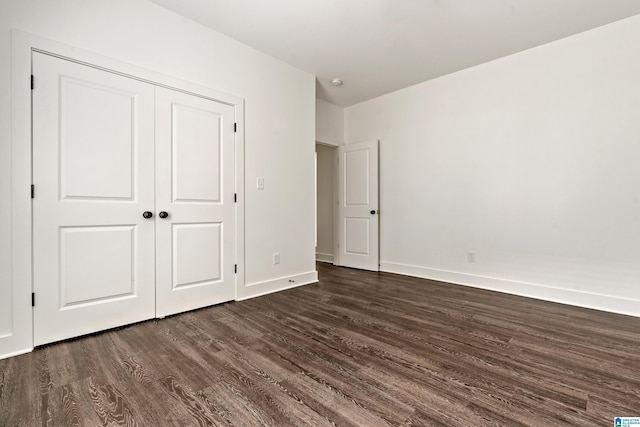 2213 3rd Ave S, Irondale, AL 35210 - unfurnished bedroom featuring dark wood-style flooring, baseboards, and a closet
