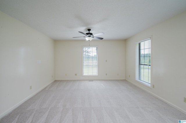 1492 Paul Allman Rd, Adger, AL 35006 - unfurnished room featuring plenty of natural light, light carpet, baseboards, a ceiling fan, and a textured ceiling