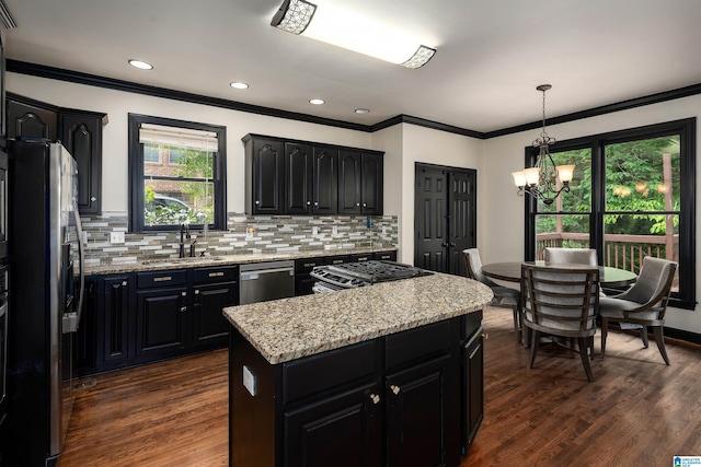 5308 Hickory Trce, Hoover, AL 35244 - kitchen with appliances with stainless steel finishes, dark cabinetry, a kitchen island, a sink, and ornamental molding