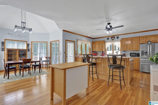 154 Baron Dr, Chelsea, AL 35043 - kitchen with stainless steel fridge with ice dispenser, light wood finished floors, light countertops, black microwave, and crown molding