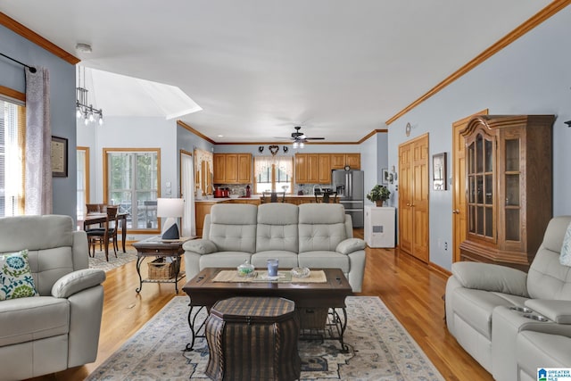 154 Baron Dr, Chelsea, AL 35043 - living room featuring light wood-style floors, ornamental molding, ceiling fan, and a chandelier