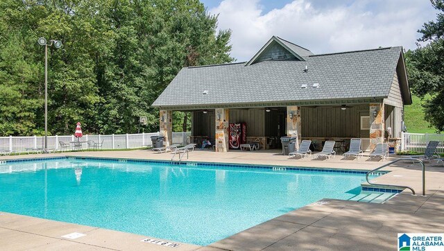 561 Boxwood Bnd, Calera, AL 35040 - community pool with a patio, fence, and an outdoor structure