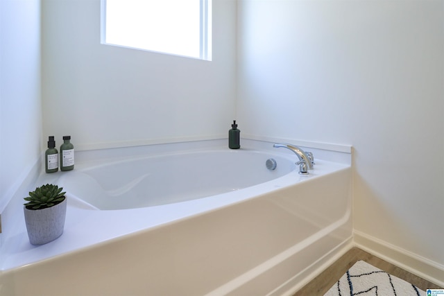 561 Boxwood Bnd, Calera, AL 35040 - full bath with a garden tub, wood finished floors, and baseboards