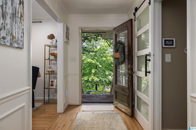 4121 Winston Way, Birmingham, AL 35213 - doorway to outside with light wood finished floors, crown molding, and a barn door