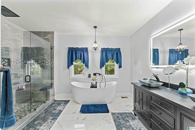 7 Stillwaters Trl, Sylacauga, AL 35151 - bathroom featuring baseboards, marble finish floors, a chandelier, a stall shower, and a soaking tub