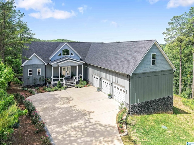 7 Stillwaters Trl, Sylacauga, AL 35151 - view of front of home featuring a porch, driveway, board and batten siding, and an attached garage
