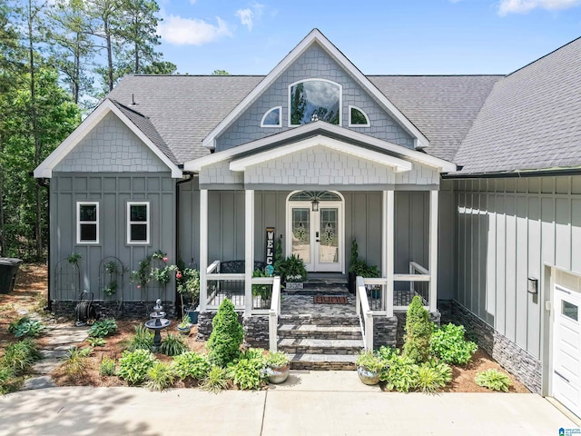 7 Stillwaters Trl, Sylacauga, AL 35151 - view of front of home featuring board and batten siding, a porch, a shingled roof, and french doors