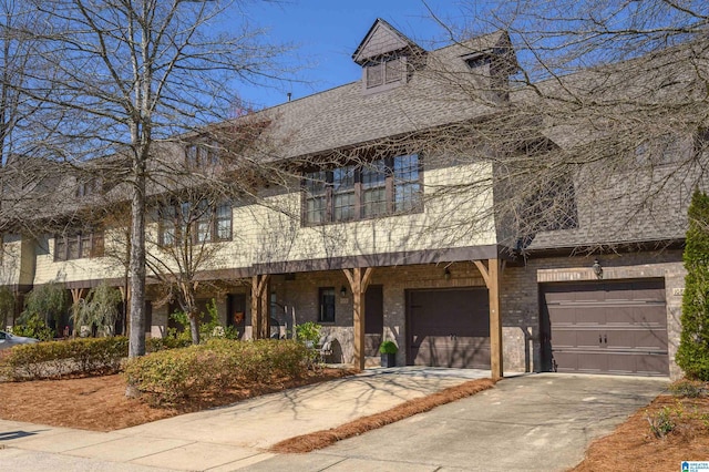 view of front of house with a garage, concrete driveway, and roof with shingles