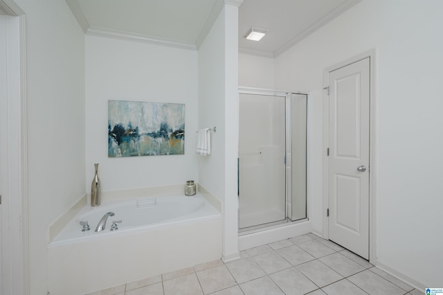 bathroom featuring crown molding, a shower stall, tile patterned flooring, and a garden tub