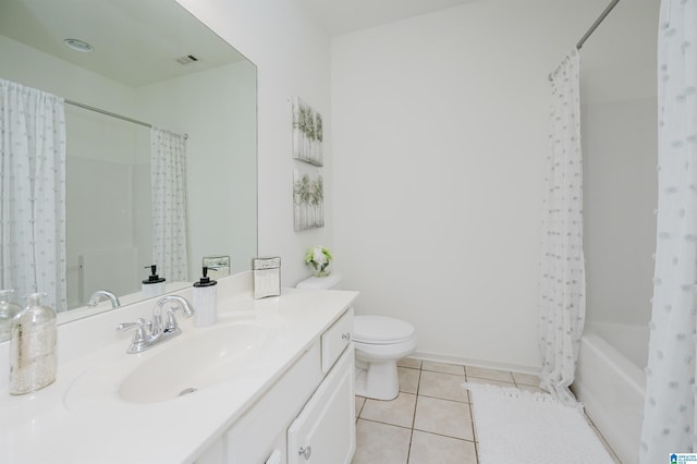 full bathroom with tile patterned floors, toilet, vanity, and shower / bath combo