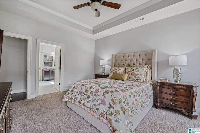 bedroom featuring carpet flooring, ornamental molding, a ceiling fan, a tray ceiling, and baseboards