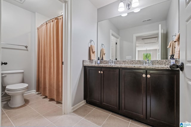 bathroom with tile patterned floors, toilet, vanity, and baseboards