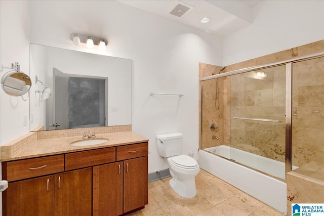 full bathroom with toilet, vanity, bath / shower combo with glass door, and tile patterned flooring