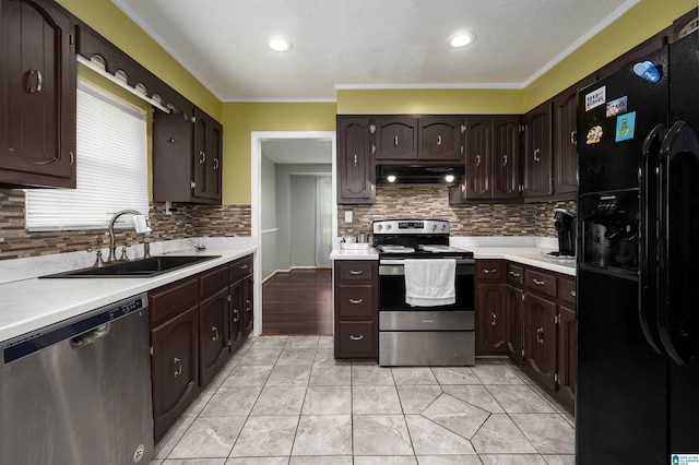500 2nd Ter, Pleasant Grove, AL 35127 - kitchen with appliances with stainless steel finishes, under cabinet range hood, a sink, light countertops, and dark brown cabinetry