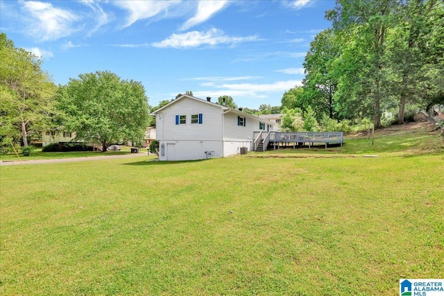 rear view of property with a wooden deck, cooling unit, a yard, and stairway
