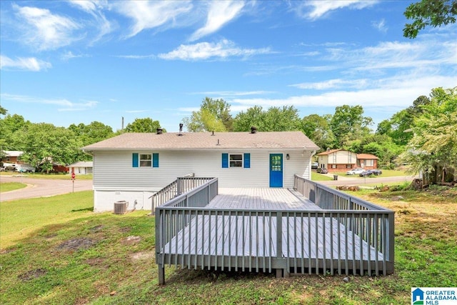 rear view of property with a yard, cooling unit, and a wooden deck