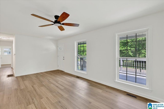 unfurnished room with light wood-style floors, ceiling fan, and baseboards