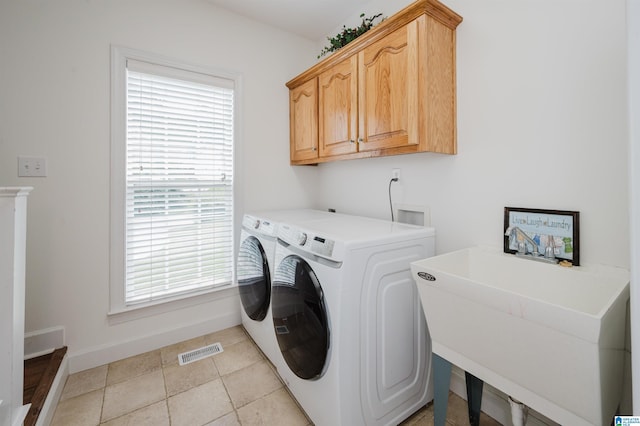 254 Macdonald Lake Rd, Springville, AL 35146 - laundry room featuring separate washer and dryer, baseboards, cabinet space, and light tile patterned flooring