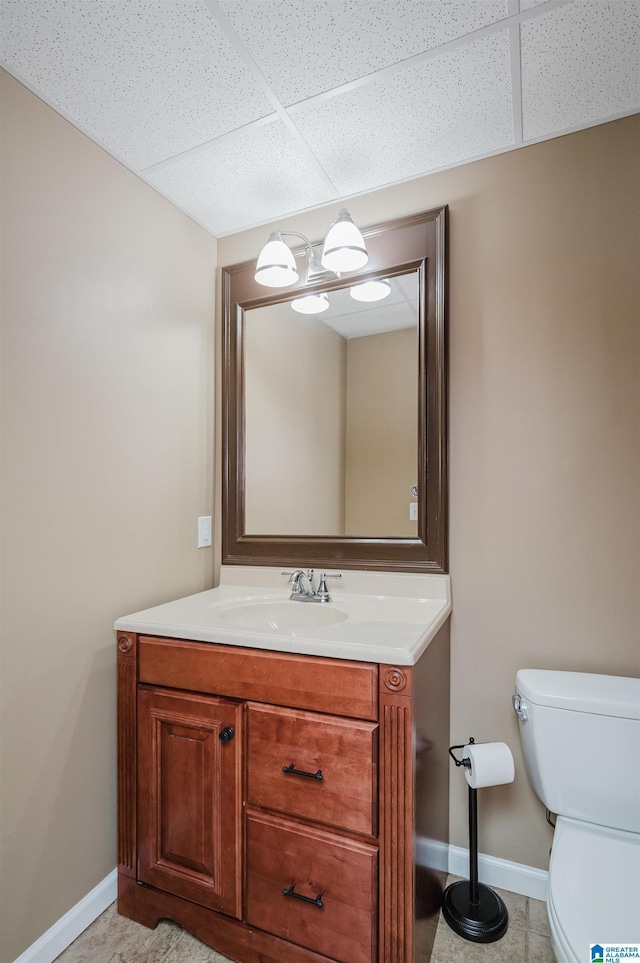 254 Macdonald Lake Rd, Springville, AL 35146 - half bathroom with baseboards, toilet, vanity, and a drop ceiling