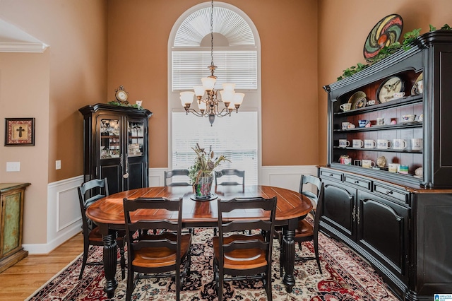 254 Macdonald Lake Rd, Springville, AL 35146 - dining room with a chandelier, light wood finished floors, wainscoting, plenty of natural light, and crown molding