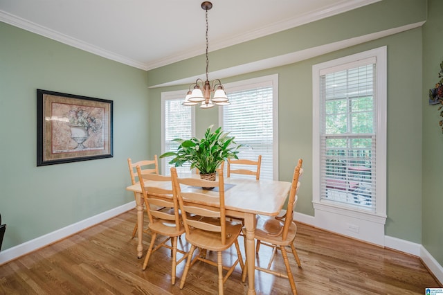 254 Macdonald Lake Rd, Springville, AL 35146 - dining area featuring crown molding, a chandelier, light wood finished floors, and baseboards
