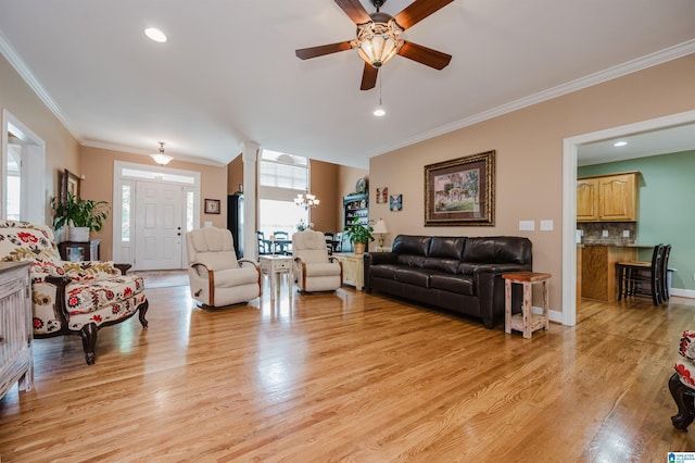 254 Macdonald Lake Rd, Springville, AL 35146 - living area with healthy amount of natural light, ceiling fan, light wood-style floors, a chandelier, and ornamental molding