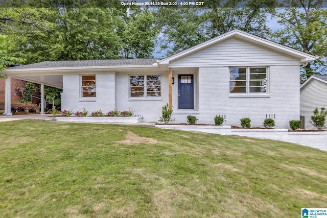 1324 Laurence St, Irondale, AL 35210 - view of front of house featuring brick siding, a front lawn, a carport, and driveway