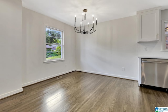 1324 Laurence St, Irondale, AL 35210 - unfurnished dining area featuring a chandelier, dark wood-style flooring, and baseboards