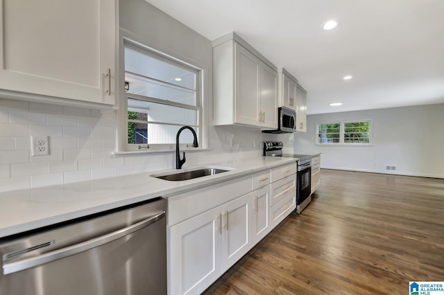 1324 Laurence St, Irondale, AL 35210 - kitchen featuring appliances with stainless steel finishes, a sink, dark wood-style floors, recessed lighting, and decorative backsplash