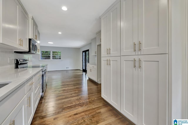 1324 Laurence St, Irondale, AL 35210 - kitchen with stainless steel appliances, recessed lighting, dark wood-style flooring, light stone countertops, and baseboards